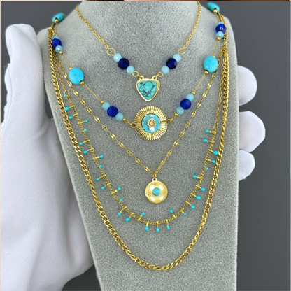 Collar doble en dorado con cuentas y charms turquesa y azul. En stainless steel y gold plating.